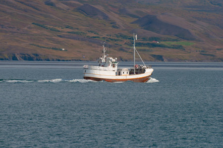 Old Icelandic fishing boat on the seaの写真素材