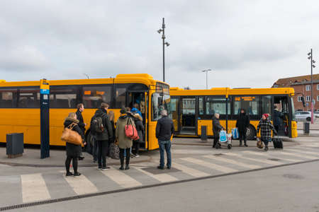 Vordingborg Denmark - March 28. 2018: Passengers in line to enter the bus in front of Vordingborg train stationのeditorial素材