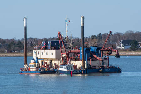 Vordingborg Denmark - April 6. 2018: Barge unloader Gylfe R in the water together with tugsのeditorial素材