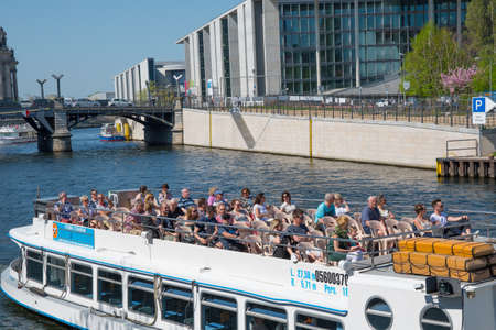 Berlin Germany - April 20. 2018: Canal tour boat sailing on River Spreeのeditorial素材