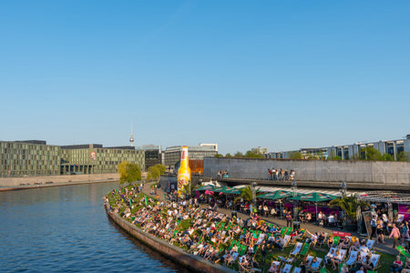 Berlin Germany - April 20. 2018: People enjoying the sunny day at the banks of Spree riverのeditorial素材