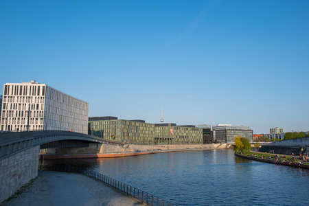 Berlin Germany - April 20. 2018: Spree river in Berlin with modern architecture and people enjoying the sunのeditorial素材