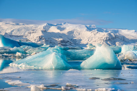 Icebergs in Jokulsarlon Glacier Lagoon in south Iceland with Vatnajokull glacier in the background