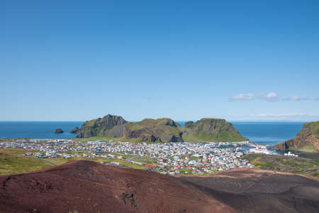 View over town of Heimaey in Iceland on a sunny summer dayの写真素材