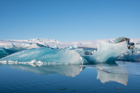 Icebergs in Jokulsarlon Glacier Lagoon in south Iceland with Vatnajokull glacier in the background