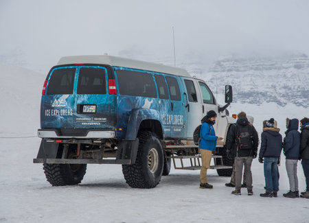 Jokulsarlon Iceland - February 5. 2019: Guide talking to tourists waiting in lin to get into a heavili modified van on the way to ice cavesのeditorial素材