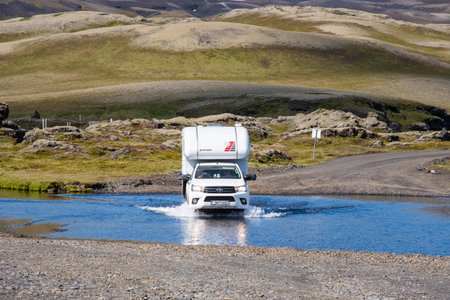 Eldgja Iceland - July 6. 2020: Toyota hilux pickup truck with a camper crossing a riverのeditorial素材