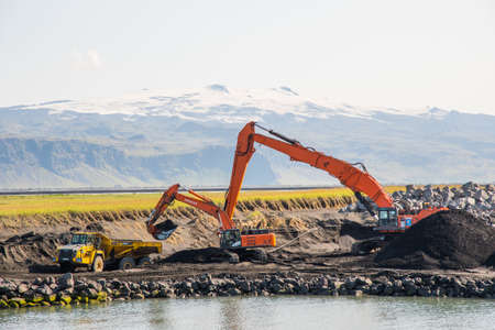 Landeyjahofn Iceland - August 9. 2019: diggers digging sand in Landeyjahofn port in south Icelandのeditorial素材