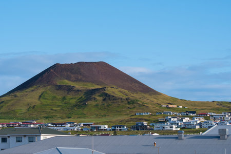 View over town of Heimaey and volcano Helgafell in Iceland on a sunny summer dayの写真素材