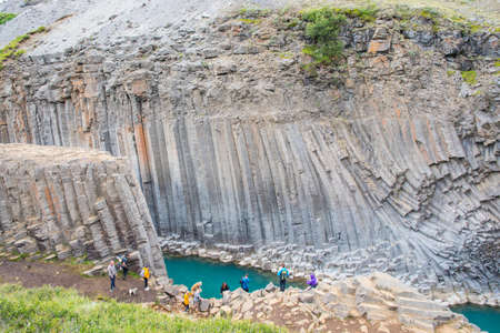 Studlagil Iceland - July 16. 2021: Tourists enjoying the stunning view of Studlagil canyonのeditorial素材