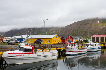 Siglufjordur, Iceland - August 5. 2021: Boats in the port of Siglufjordur with Restaurants in the backgroundのeditorial素材