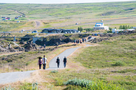 Godafoss, Iceland - August 11. 2021: Tourists on the hiking paths and sightseeing platforms of waterfall Godafossのeditorial素材