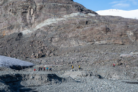 Tourists on the way towards an Ice cave in Breidamerkurjokull glacierのeditorial素材