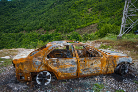 Burned down car in the mountains of North Albaniaの写真素材