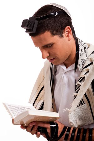 Close up of a young  jewish man with book on white isolated backgroundの写真素材