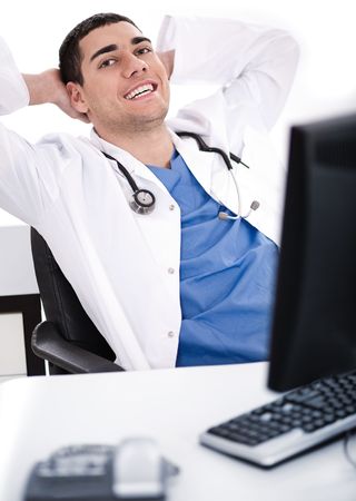 Smiling young male doctor over white backgroundの写真素材
