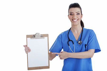 Portrait of young nurse pointing blank clipboard over isolated white backgroundの写真素材