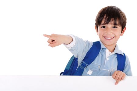 Smiling young boy standing behind the blank board and pointing us on isolated white backgroundの写真素材