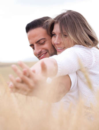 lovely couple, woman holding hands round the neck of her boyfriendの写真素材