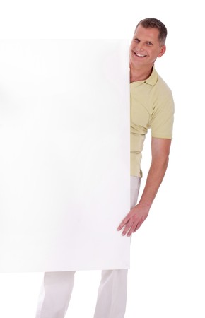 Middle aged couple standing behind a blank white board and smiling over a isolated white backgroundの写真素材