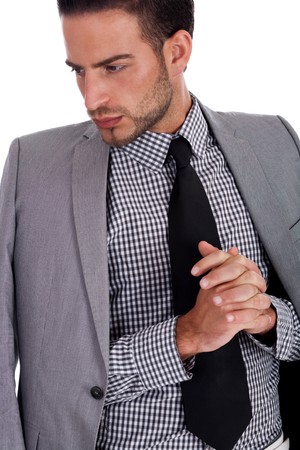 Serious  business man with his half weared suit over white backgroundの写真素材