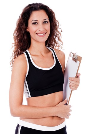 Fitness woman holding a blank clip board on a isolated white backgroundの写真素材