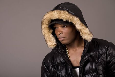 Closeup portrait of young handsome african with head cap on grey backgroundの写真素材
