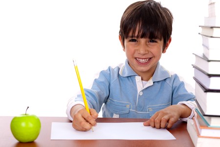 Young kid enjoying art as he draws on blank sheet of paperの写真素材