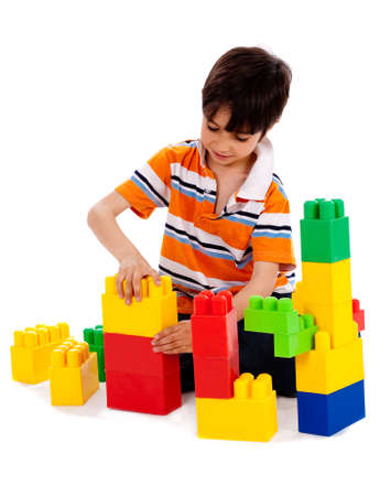Cute little boy playing on white isolated backgroundの写真素材