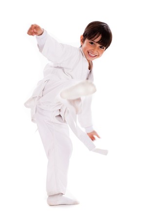 Karate kid kicking over isolated white backgroundの写真素材