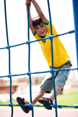 Young kid on playstructure, outdoorsの写真素材
