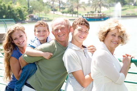 Closeup portrait of a happy family standing together in outdoorの写真素材