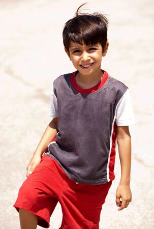Young boy posing in style, looking at cameraの写真素材