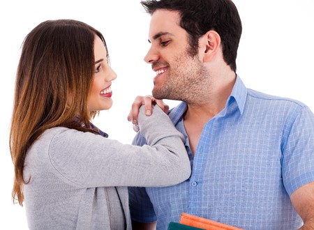 Beautiful couple smiling and facing each other on a isolated white backgroundの写真素材