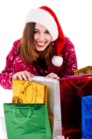 portrait of lady wearing santa hat enjoying her christmas giftsの写真素材