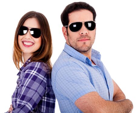closeup of couple wearing sunglasses standing back to backの写真素材