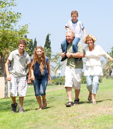 portrait of playfull family running towards cameraの写真素材
