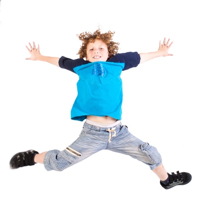 Attractive young kid jumping high, indoors.の写真素材