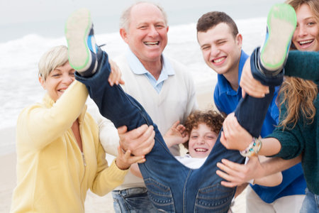 Happy family with kid having fun at the beach