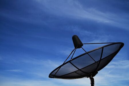 Satellite dish in blue sky の写真素材