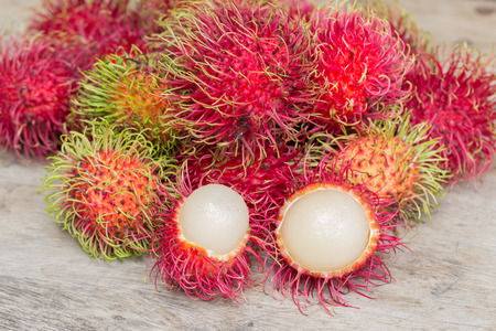 Lot of Fresh rambutan on wood Floorの写真素材