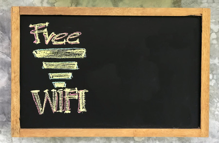 black board note Free wifi hang on wall with copy spaceの写真素材