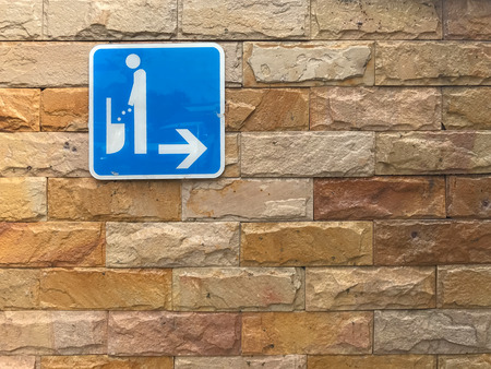 WC or toilet sign on brick wallの写真素材