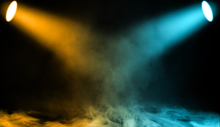 Colorful projector. Spotlight stage with smoke on the floor . Isolated background texture.の写真素材