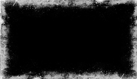 Vintage scratched grunge border overlays on isolated black background for copyspace.の写真素材