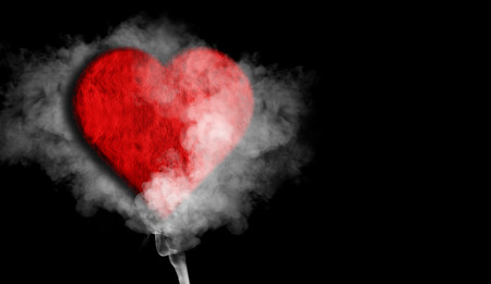 Romantic red love heart with smoke on background for copy spaceの写真素材