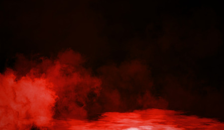 Red smoke on the floor . Isolated black background . Misty fog effect texture overlays for text or spaceの写真素材