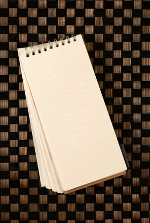 Open blank note book on bamboo textureの写真素材