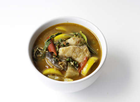 Thai style food Red curry cook with Asian Redtail Catfish and herb. の写真素材