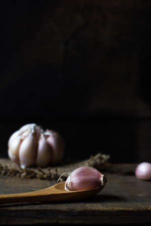 garlic on vintage wooden dark lightの写真素材